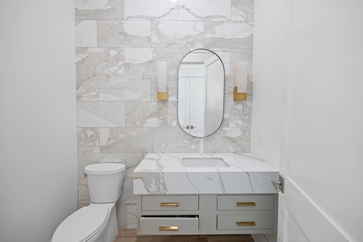 shot of bathroom with toilet and vanity with mirror